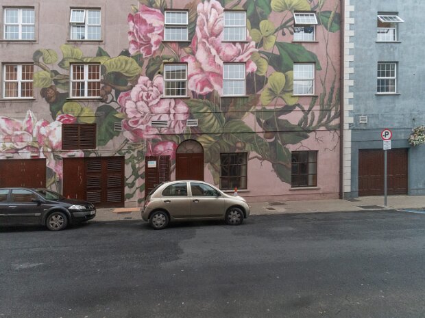 FLOWERS ON THE STREET BY LULA GROCE The story begins with the original mural's creator, Lula Goce. A Spanish artist with a distinctive path, her work is...