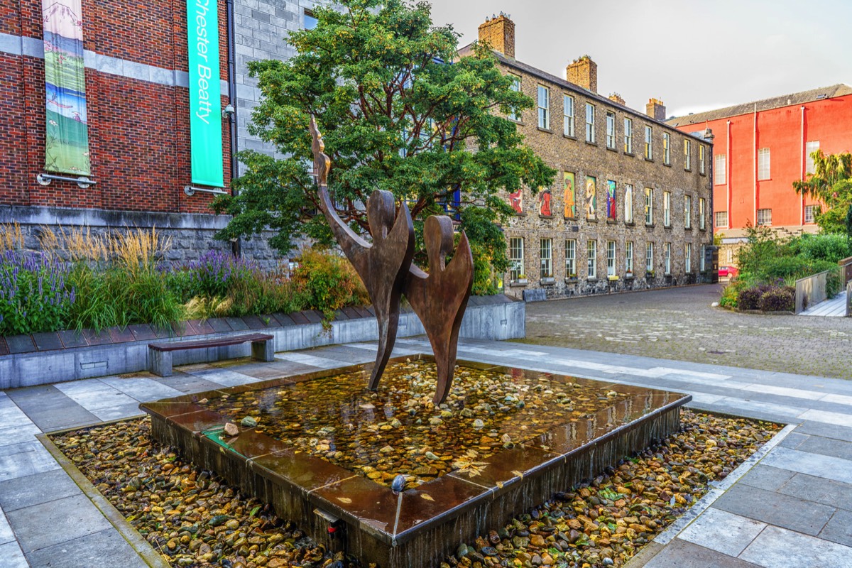 TWO STYLISED FIGURES WITH THE OLYMPIC FLAME - SPECIAL OLYMPICS MEMORIAL BY JOHN BEHAN 001