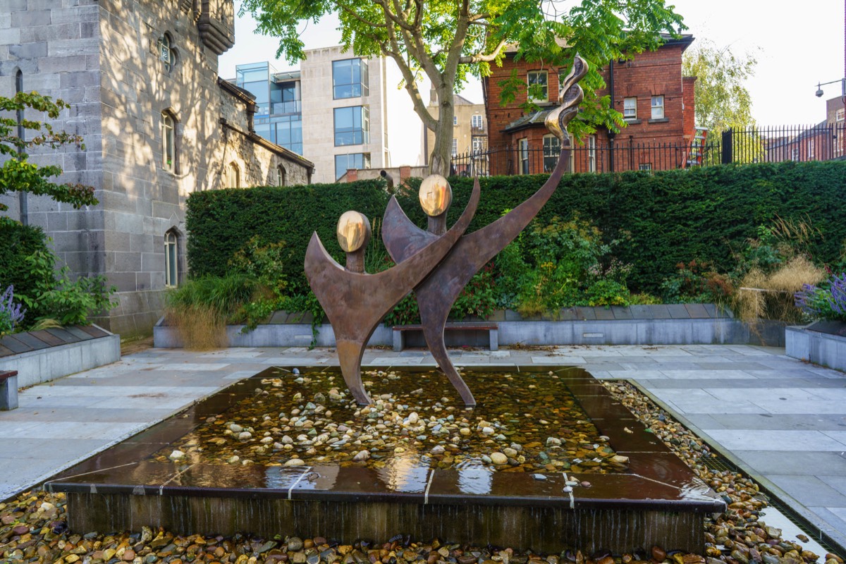 TWO STYLISED FIGURES WITH THE OLYMPIC FLAME - SPECIAL OLYMPICS MEMORIAL BY JOHN BEHAN 004